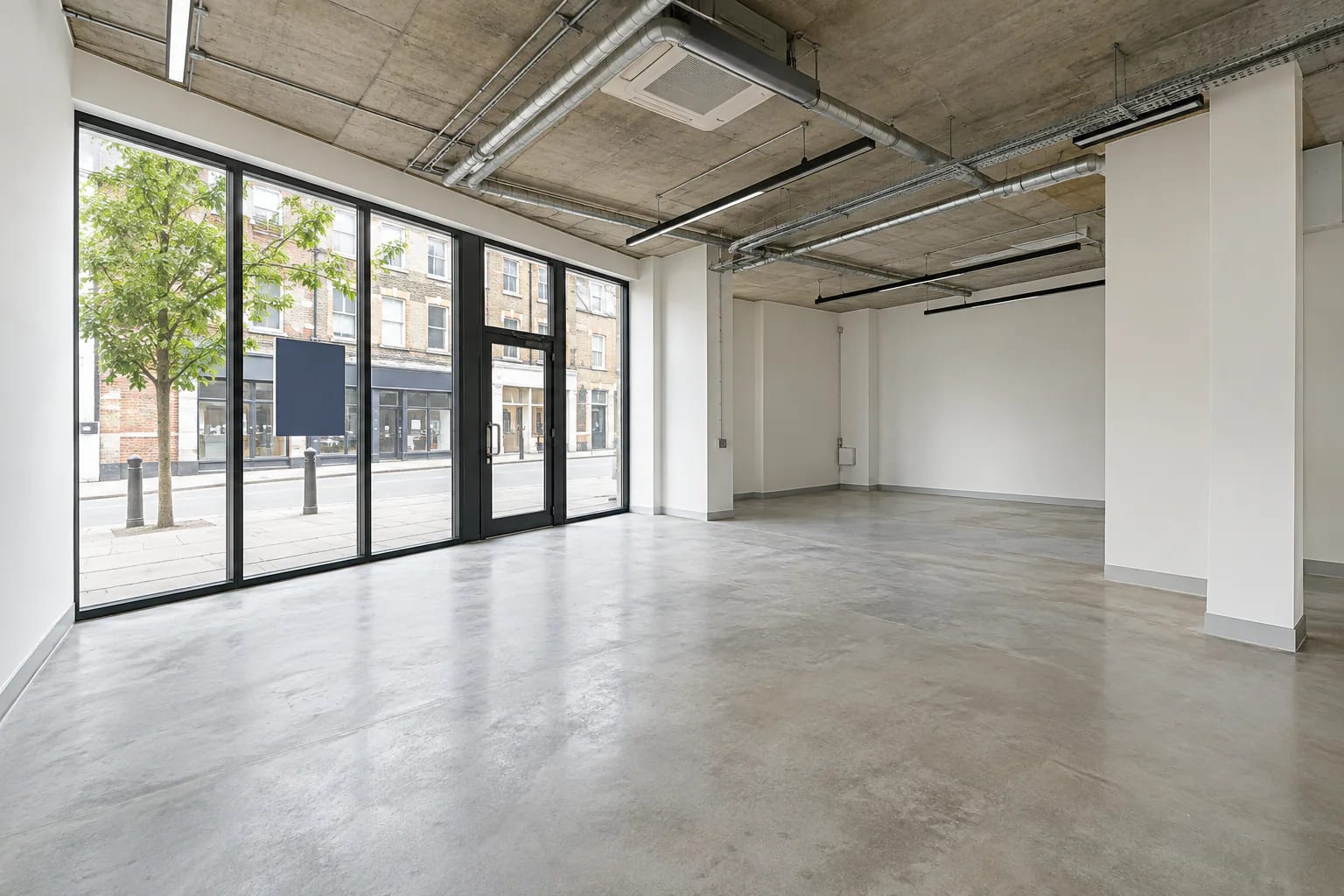 Empty, freshly painted retail unit with To Let board in the window