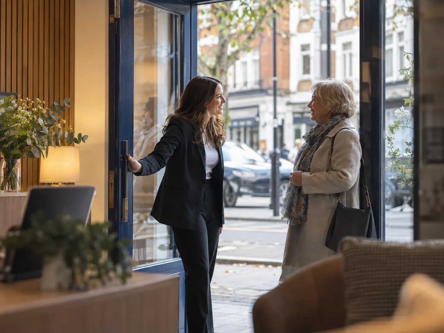 M & K team member greeting a client at the office door